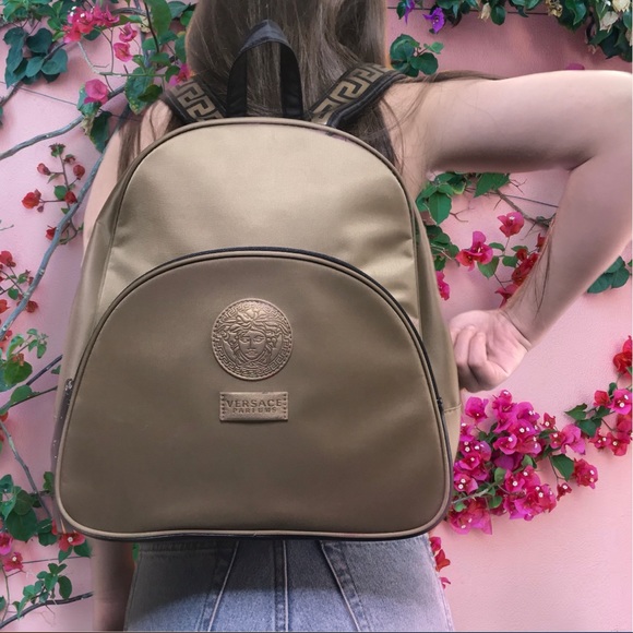 pink versace perfume with backpack